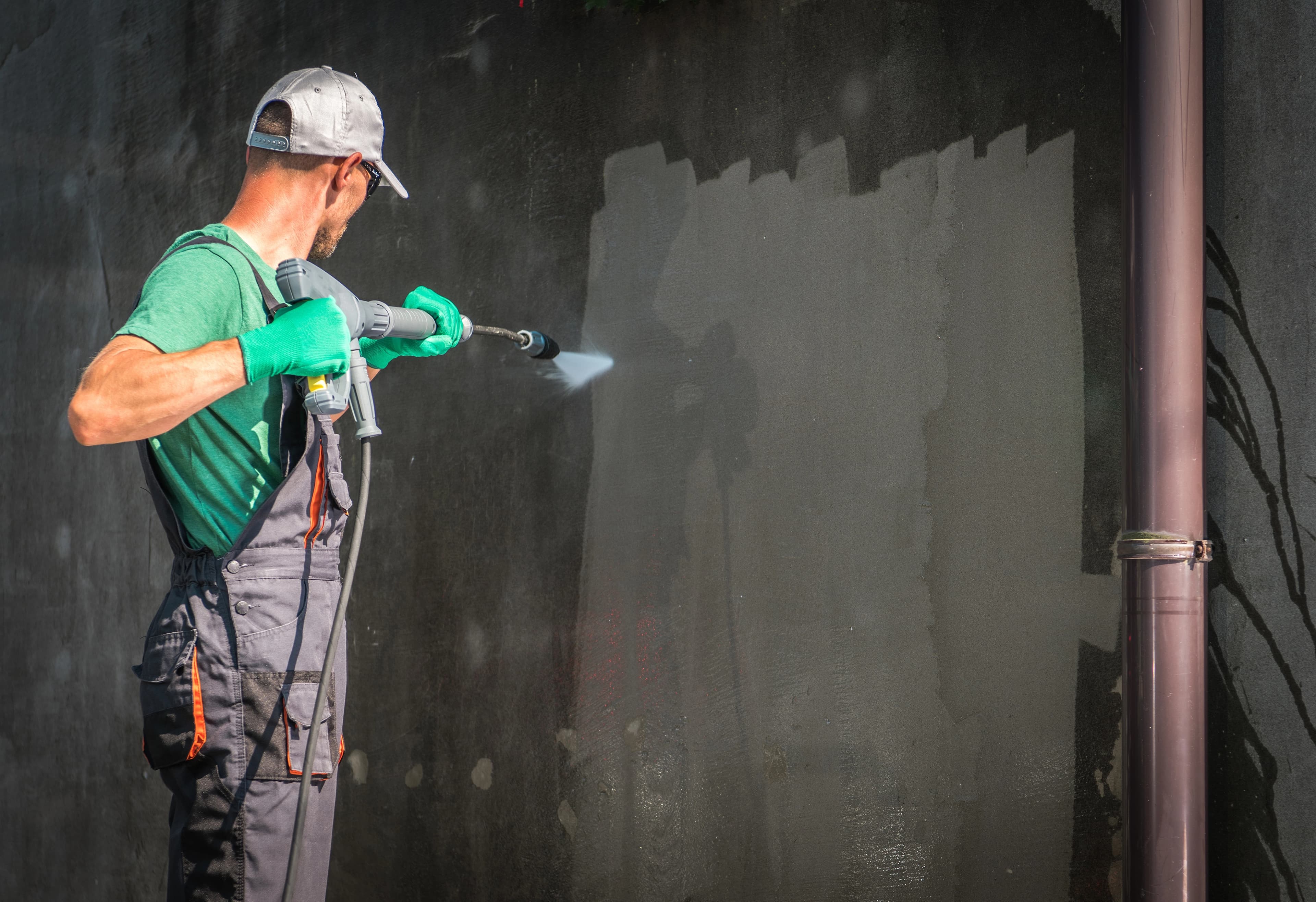 Power washing crew cleaning home siding