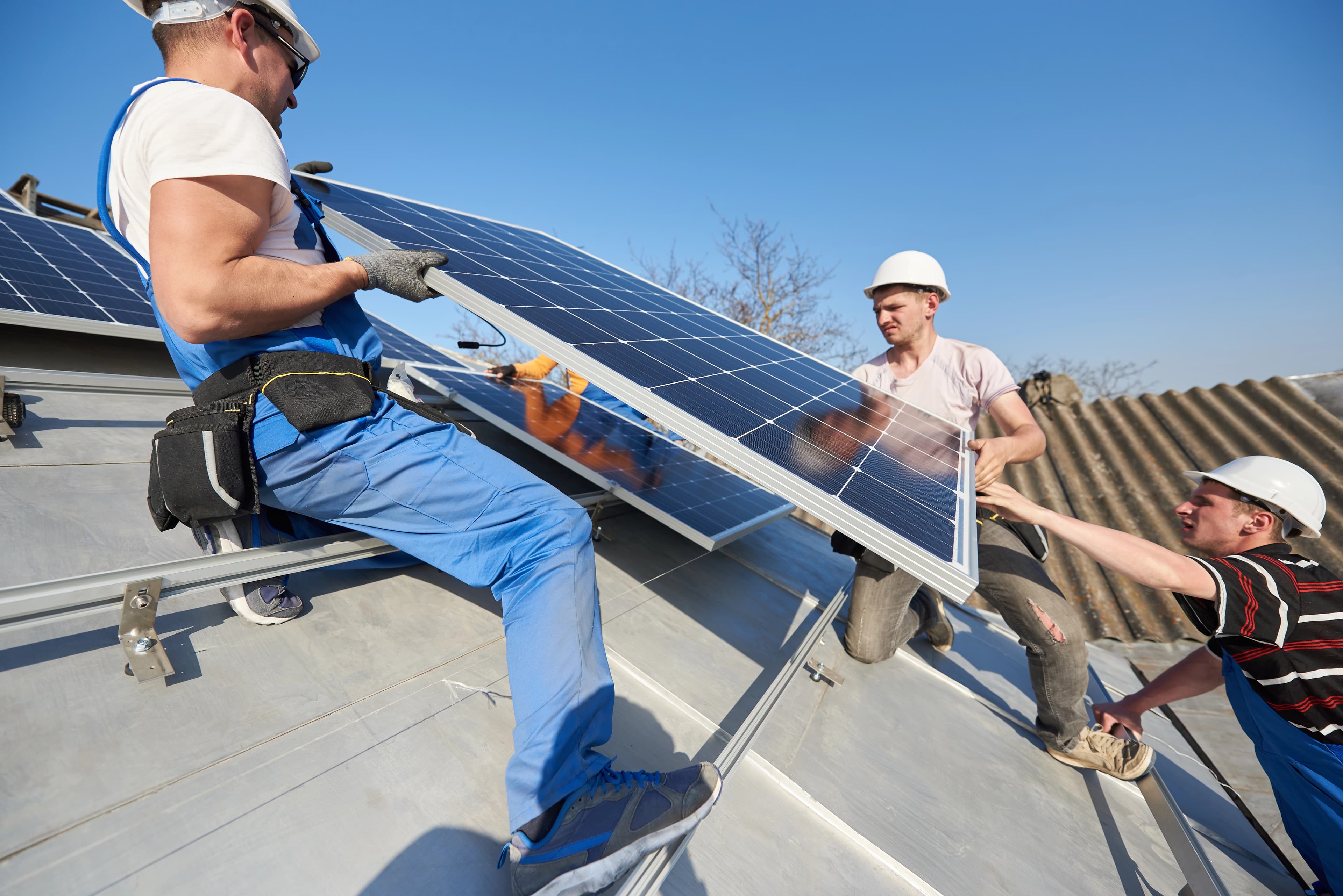 Crew working from a bucket truck on a rooftop install